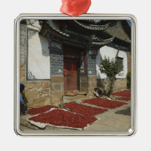 CHINA, Yunnan Province, Tianshengying. Drying Metal Ornament