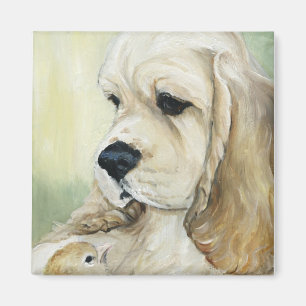 Chiot de cocker et aimant de poussin