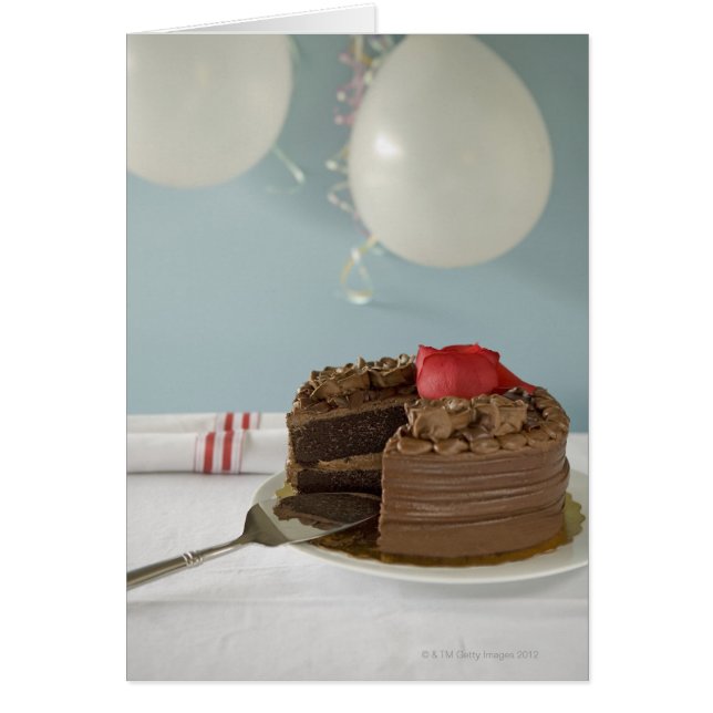 Chocolate cake with missing slice on table, (Front)