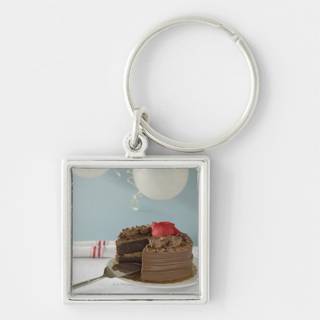 Chocolate cake with missing slice on table, keychain (Front)