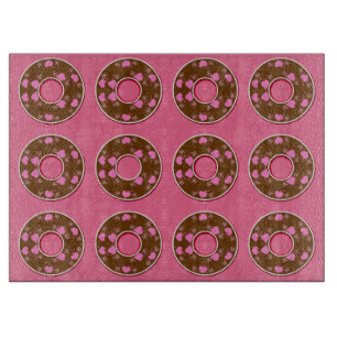 Chocolate doughnuts doughnuts on pink cutting boar cutting board