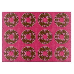 Chocolate doughnuts on hot pink cutting board