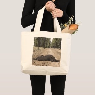 Chocolate Labrador Puppy Lying On A Forest Trail Large Tote Bag