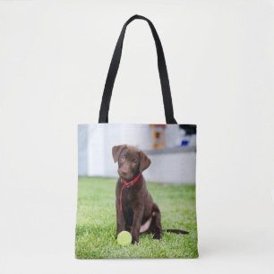 Chocolate Labrador Puppy With Tennis Ball Tote Bag