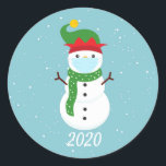 Christmas 2020 Face Mask Snowman Quarantine Classic Round Sticker<br><div class="desc">This design was created though digital art.  It may be personalized 

Contact me at colorflowcreations@gmail.com if you with to have this design on another product.  

Purchase my original abstract acrylic painting for sale at www.etsy.com/shop/colorflowart.   See more of my creations or follow me at www.facebook.com/colorflowcreations,  www.instagram.com/colorflowcreations,  www.twitter.com/colorflowart,  and www.pinterest.com/colorflowcreations.</div>