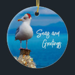 Christmas Beach Seas and Greetings Seagull Ocean Ceramic Ornament<br><div class="desc">This design may be personalized by choosing the Edit Design option. You may also transfer onto other items. Contact me at colorflowcreations@gmail.com or use the chat option at the top of the page if you wish to have this design on another product or need assistance. See more of my designs...</div>