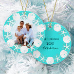 Christmas Beach Wreath Sand Dollar Starfish Ceramic Ornament<br><div class="desc">A wreath of white sand dollars, starfish, and aqua glitter coral frame the family photo on the front of this beach themed ornament, with an aqua blue background, with family name, year, and Merry Christmas on the back. Please contact me through Zazzle Chat if you need matching products, design tweaks...</div>