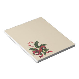 Christmas candy cane in a mistletoe and holly berr notepad