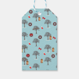 Christmas decorations and trees under snow gift tags
