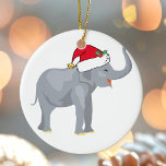 Christmas Elephant Ceramic Ornament<br><div class="desc">Cute holiday animals are my favourite part of Christmas. A beautiful elephant wearing a red Santa hat and looking happy. This fills me with the Christmas spirit.</div>