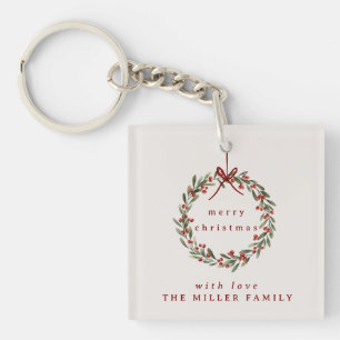 Christmas foliage wreath with red bow. keychain