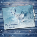 Christmas from Montana Deer Christmas Card<br><div class="desc">Send a bit of Montana to your friends and family this Holiday Season, with this stunning photograph of a buck deer standing at the edge of a mountain forest with snowflakes drifting down around him. The text in blue at the bottom can be changed to anything you'd like, as can...</div>