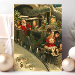 Christmas Greetings Train Vintage Holiday Postcard<br><div class="desc">Beautiful vintage Christmas Train postcard. "Christmas Greetings" written in the lower left corner. This design features a Santa Claus train conductor with two little children hitching a ride on the front of the train.</div>