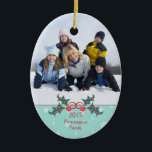 Christmas holly customizable family photo ornament<br><div class="desc">This oval shaped ceramic ornament has a Christmas holiday design.  At the bottom,  there is a holly berry bush with the year and family name that is easily customizable with your text.  At the top,  you can add your own photograph.  Copyright © Sarah Paris</div>