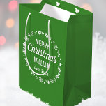 Christmas Love Santa Personalized Name Green Medium Gift Bag<br><div class="desc">Create your own 'Love,  Santa' gift bag with this fun and festive design! A stylish template,  personalized with the recipient's name and featuring an illustrated border with snowflakes,  holly,  Christmas stockings and stars. An unique way of presenting a gift to someone special! Colours: green and white.</div>
