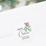 Christmas Mistletoe  Classic Round Sticker<br><div class="desc">This festive sticker is decorated with green watercolor mistletoe,  a red ribbon,  and stylish script typography. 
Easily Customizable.
Original Watercolor © Michele Davies.</div>