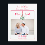 Christmas Mistletoe Photo Save The Date Card<br><div class="desc">Modern yet elegant save the date card perfect for a Christmas themed wedding. It features a mistletoe hanging with a red ribbon. A thin frame around the card gives it a sophisticated touch. Add your own photo for a special personal touch. Romantic design with the couple kissing under a mistletoe....</div>