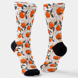 Christmas oranges with green leaves on white socks