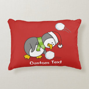 Christmas penguin getting a snow ball accent pillow
