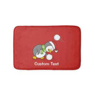 Christmas penguin getting a snow ball bath mat