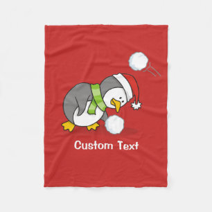 Christmas penguin getting a snow ball fleece blanket