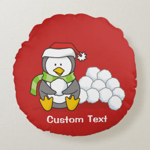 Christmas penguin sitting with snow balls round pillow