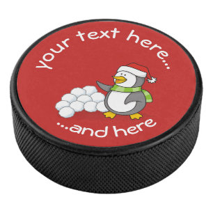 Christmas penguin with snow balls waving hockey puck