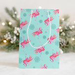 Christmas Pink Flamingo Snowflake Medium Gift Bag<br><div class="desc">Wrap your holiday gifts in tropical style with this festive Christmas gift bag, featuring a watercolor pink flamingo and delicate snowflakes on a vibrant turquoise blue background. Inspired by sunny Florida holidays, this design is perfect for beach-themed Christmas gifts, Pinkmas parties, or stylish gifts with a coastal twist. Whether you're...</div>