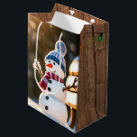 Christmas Snowman On a Park Bench Medium Gift Bag<br><div class="desc">Cute Christmas snowman on a park bench in a winter forest with sunbeams.
Text is editable.</div>