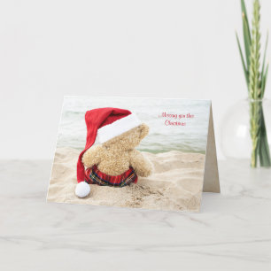 Christmas teddy bear on beach holiday card