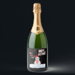 Christmas The Snowman Sparkling Wine Label<br><div class="desc">These sparkling wine labels showcase the words "Merry Christmas Ho Ho Ho" in a unique print font with multi-coloured letters and Christmas The Snowman wear red and white with snow falling in the background in this X-mas theme and style. All labels are printed with photo-quality printing great for customizing weddings,...</div>