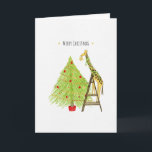Christmas Tree and Giraffe on a Ladder Holiday Card<br><div class="desc">This is a fun little Christmas card design featuring an illustration of a giraffe putting the star on top of the Christmas tree,  but even the giraffe needs to use a ladder to reach the top of the tree.

Design and Illustration by Natalie Kinnear</div>