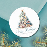 Christmas Tree Beach Classic Round Sticker<br><div class="desc">Christmas Tree Beach Classic Round Sticker. Spread some beachy holiday cheer with this unique round sticker featuring a Christmas tree made of shells and starfish. The tree, topped with a starfish, is designed in calming blue and green hues, reminiscent of underwater coral, and is set against a sandy base. This...</div>