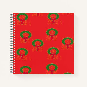 Christmas wreath on red notebook