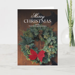 Christmas wreath on wood door holiday card