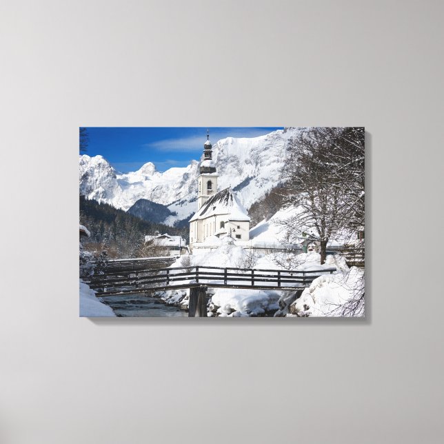 Church in the snow with Alps mountains Canvas Print (Front)