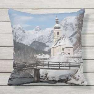 Church in the snow with Alps mountains in winter Outdoor Pillow