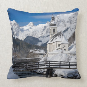 Church in the snow with Alps mountains Throw Pillow