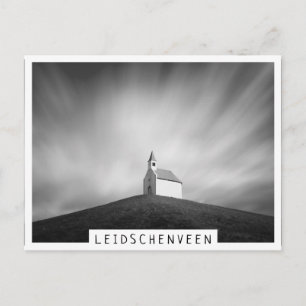 Church on a hill in black and white postcard