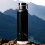 Classic Black Gold Minimalist Monogram Name Water Bottle<br><div class="desc">Elevate your hydration routine with our Classic Elegant Modern Minimalist Monogram Black Water Bottle. Meticulously designed, this water bottle seamlessly merges timeless sophistication with contemporary minimalism, making it a stylish and functional accessory for your daily life. Crafted with precision and attention to detail, this water bottle is more than just...</div>