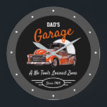 Classic Chevy Truck Garage Dad's Any Name Black Large Clock<br><div class="desc">Dad's or any name garage with 50's Chevy on a black background with orange script and a grey border. Just use the personalize this template option to change the text. Funny slogan typography with any date. Just choose the hand colour and size.</div>