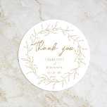 Classic Gold Greenery Wedding Thank You Round Sticker<br><div class="desc">Introducing our Classic Gold Greenery Wedding Thank You Classic Round Sticker Design- meticulously designed to embody a modern romantic aesthetic. Featuring a classic blend of clean white backgrounds with delicate golden leaves gracefully complemented by a simple calligraphy script paired with an understated serif font. The result is a perfectly polished...</div>