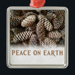 Classic Holiday Pine Cone Peace On Earth Metal Ornament<br><div class="desc">Festive,  earthy pine cones set off this classic,  elegant design wishing Peace On Earth.</div>