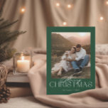 Classic Modern Christmas Card with Photo<br><div class="desc">This Christmas photo card features a modern, yet festive design with a single prominent photo on the front. The background is a rich green, evoking a classic holiday vibe reminiscent of evergreen trees. Centred above or below the photo, the text "Merry Christmas" is displayed in a elegant and modern font...</div>