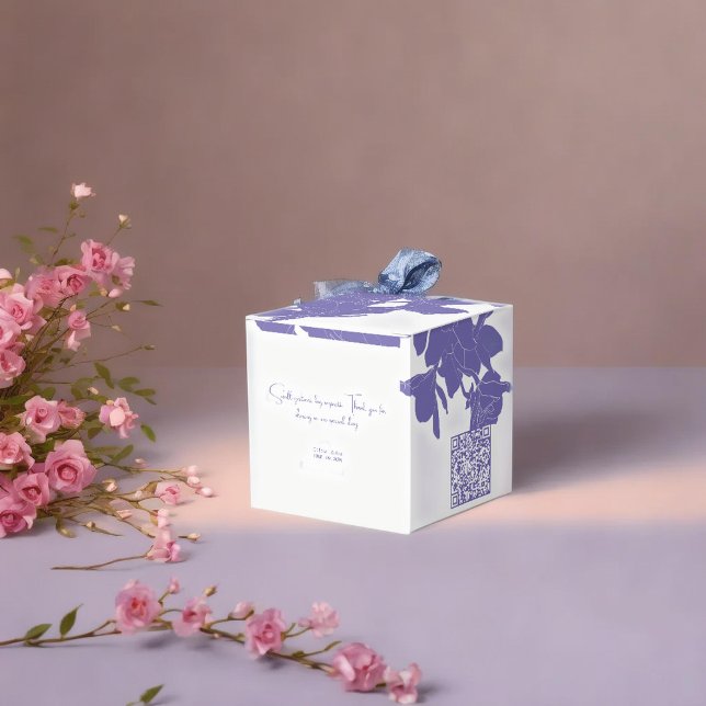 classy white & purple flowry  favor box (Luxury purple flowry favor boxes on soft surface next to pink flowers with warm up light )