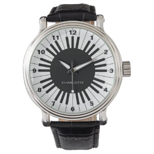 Clavier de piano, montre noire et blanche