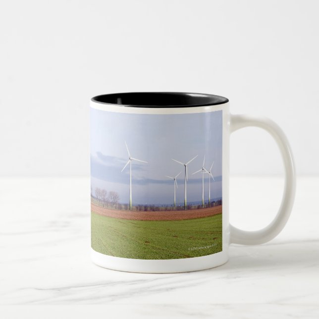 Clean energy by many wind turbines on fields. Two-Tone coffee mug (Right)