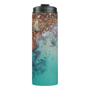 Clear blue sea and rocks thermal tumbler