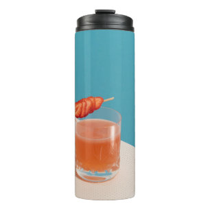 Clear drinking glass with brown liquid thermal tumbler