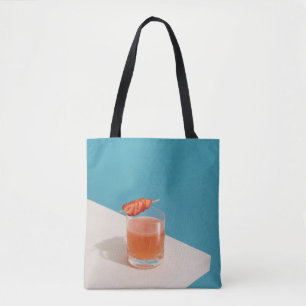 Clear drinking glass with brown liquid tote bag